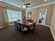 Inviting dining room featuring a modern ceiling fan, dining set, and natural light from the large window at 1601 Bonica Xing # 1601, Cumming, GA 30040