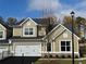 New two-story home featuring an attached two-car garage, manicured lawn, and craftsman-style details at 1601 Bonica Xing # 1601, Cumming, GA 30040