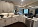 Open kitchen with marble countertops, white cabinetry, stainless steel appliances, and dark hardwood floors at 1601 Bonica Xing # 1601, Cumming, GA 30040
