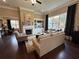 Bright living room boasts a fireplace, built-in shelving, hardwood floors, and large windows at 1601 Bonica Xing # 1601, Cumming, GA 30040
