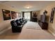 Home theater featuring tiered seating, movie posters, and a large screen for an immersive viewing experience at 1601 Bonica Xing # 1601, Cumming, GA 30040