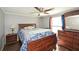 Bedroom features a ceiling fan and dark-wood furniture, including a dresser with a large mirror at 177 Carolyn Se Ct, Acworth, GA 30101