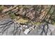Aerial view of the home with multiple decks and patio spaces nestled among the trees at 2724 Janellen Dr, Atlanta, GA 30345