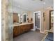 This bathroom features double sinks, wood cabinets, light colors, and a private toilet area at 2724 Janellen Dr, Atlanta, GA 30345