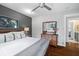 Well-lit bedroom featuring a dresser, ceiling fan, hardwood floors, and ensuite bathroom access at 2724 Janellen Dr, Atlanta, GA 30345