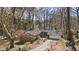 Exterior shot of a home with a long driveway, mature landscaping, and a two-car garage at 2724 Janellen Dr, Atlanta, GA 30345