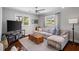Cozy living room with a sectional sofa, TV, wood floors, and natural light at 2724 Janellen Dr, Atlanta, GA 30345