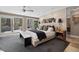 Main bedroom featuring a door to the backyard, carpet flooring, side table and ceiling fan at 2724 Janellen Dr, Atlanta, GA 30345