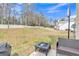 Large backyard featuring a fire pit, basketball hoop, and a generous grassy area at 4145 Alveston Dr, Atlanta, GA 30349