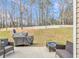 Spacious backyard showcasing outdoor seating, a grill, and fire pit at 4145 Alveston Dr, Atlanta, GA 30349