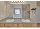 Bright bathroom featuring double sinks, a large mirror, and a garden tub at 4145 Alveston Dr, Atlanta, GA 30349
