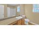 Bright bathroom featuring a well-lit mirror, modern vanity, and white toilet at 4145 Alveston Dr, Atlanta, GA 30349