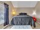 Cozy bedroom featuring a large bed, neutral walls, and natural light from the window at 4145 Alveston Dr, Atlanta, GA 30349