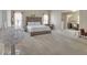 Large primary bedroom with a tufted headboard, sitting area, and connecting living space at 4145 Alveston Dr, Atlanta, GA 30349