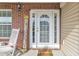 A cozy front porch featuring brick accents, a rocking chair, and a decorative welcome sign at 4145 Alveston Dr, Atlanta, GA 30349