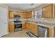 Well-lit kitchen featuring stainless steel appliances and abundant storage solutions for cooking convenience at 4145 Alveston Dr, Atlanta, GA 30349