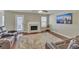 Cozy living room with a fireplace, plush rug, leather reclining sofa and a large screen TV on the wall at 4145 Alveston Dr, Atlanta, GA 30349