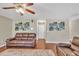 Comfortable living room features a plush rug, leather reclining sofa and artwork on the wall at 4145 Alveston Dr, Atlanta, GA 30349
