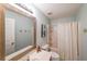 Bathroom features a large mirror, shower-tub and decorative wall art at 515 Roland Manor Dr, Dacula, GA 30019