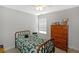 Bedroom with carpet, window, and traditional wood furniture at 515 Roland Manor Dr, Dacula, GA 30019