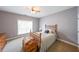 Cozy bedroom with carpet, window and charming antique furniture at 515 Roland Manor Dr, Dacula, GA 30019