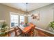 Bright dining area with stylish light fixture and views to the backyard at 515 Roland Manor Dr, Dacula, GA 30019