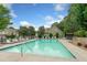 Community pool with lounge chairs and view of surrounding homes and trees at 515 Roland Manor Dr, Dacula, GA 30019