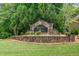 Stone entrance sign for Legacy River neighborhood amidst green trees at 515 Roland Manor Dr, Dacula, GA 30019