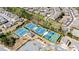 Aerial view of community tennis courts and surrounding trees and neighborhood at 6210 Bellmoore Park Ln, Duluth, GA 30097