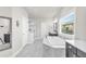 Bright bathroom featuring a marble tub, separate shower, and double vanity sinks at 6210 Bellmoore Park Ln, Duluth, GA 30097