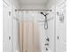 Bathroom featuring a shower-tub combination with white tile surround and a neutral shower curtain at 6210 Bellmoore Park Ln, Duluth, GA 30097