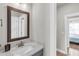 Bathroom featuring a vanity with a white countertop, wood framed mirror, and entry view at 6210 Bellmoore Park Ln, Duluth, GA 30097