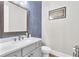 Powder room features blue accent wall, modern sink, and updated fixtures at 6210 Bellmoore Park Ln, Duluth, GA 30097