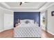 Main bedroom features a tray ceiling, wood floors and a blue accent wall at 6210 Bellmoore Park Ln, Duluth, GA 30097