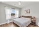 Comfortable bedroom featuring a bed with wood headboard and bright natural light at 6210 Bellmoore Park Ln, Duluth, GA 30097