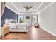 Main bedroom features a tray ceiling, wood floors and a blue accent wall at 6210 Bellmoore Park Ln, Duluth, GA 30097