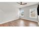 A spacious bedroom featuring wood floors, neutral walls, and two windows at 6210 Bellmoore Park Ln, Duluth, GA 30097