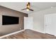 A bedroom featuring wood floors, a modern ceiling fan, and a mounted television at 6210 Bellmoore Park Ln, Duluth, GA 30097