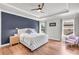 Main bedroom features a tray ceiling, wood floors and a blue accent wall at 6210 Bellmoore Park Ln, Duluth, GA 30097