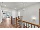 Hallway with natural light, hardwood floors and wooden railing at 6210 Bellmoore Park Ln, Duluth, GA 30097