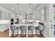 Modern kitchen featuring marble countertops, a breakfast bar, pendant lighting, and stainless appliances at 6210 Bellmoore Park Ln, Duluth, GA 30097