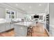 Spacious kitchen with stainless appliances and island, seamlessly flowing into an open-concept living area at 6210 Bellmoore Park Ln, Duluth, GA 30097