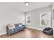 Bright living room with wood floors, a gray couch, and a comfortable bean bag at 6210 Bellmoore Park Ln, Duluth, GA 30097