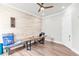 Office space with wood paneled accent wall, contemporary desk, and natural light at 6210 Bellmoore Park Ln, Duluth, GA 30097