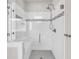 Walk-in shower featuring glass doors, white subway tile, and accent mosaic tile at 6210 Bellmoore Park Ln, Duluth, GA 30097