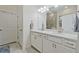 This bright bathroom features a double vanity, a large mirror, and a tiled floor at 1098 Central Park Rd, Decatur, GA 30033