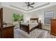 This bedroom features a tray ceiling, a ceiling fan, two windows, and an area rug at 1098 Central Park Rd, Decatur, GA 30033
