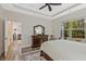 This bedroom is bright with wood floors and a beautiful view of the backyard through a window at 1098 Central Park Rd, Decatur, GA 30033
