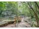 Stone path and bridge over a creek surrounded by lush green trees at 1098 Central Park Rd, Decatur, GA 30033