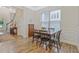 Dining area with hardwood floors, wainscotting, a window with blinds and a dark wooden table at 1098 Central Park Rd, Decatur, GA 30033